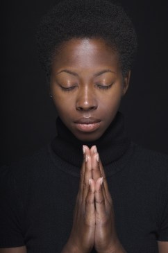 Close up of African woman praying